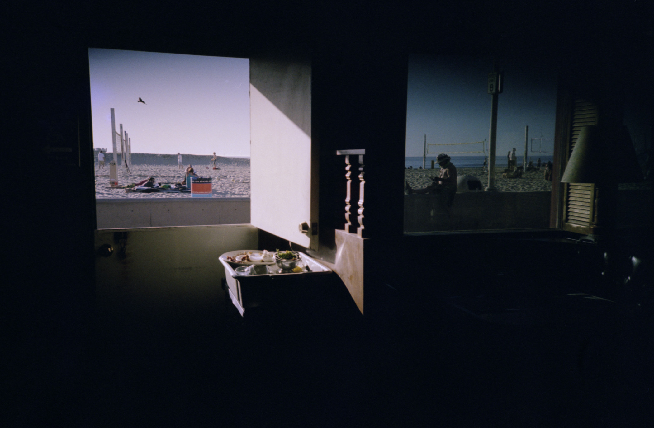 Y2K Dayshifting — a dark dive bar looking out onto a sunny Hermosa Beach, California in spring 2000.